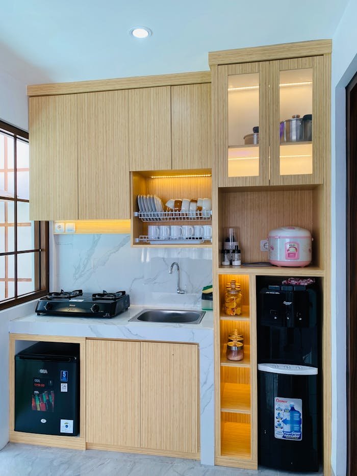 Stylish small kitchen with wooden cabinets, sink, and appliances.